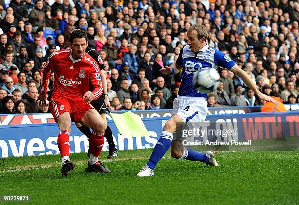 Maxi Rodriguez of Liverpool goes up with Lee Bowyer of Birmingham during the Barclays Premier League match between Birmingham City and Liverpool at...