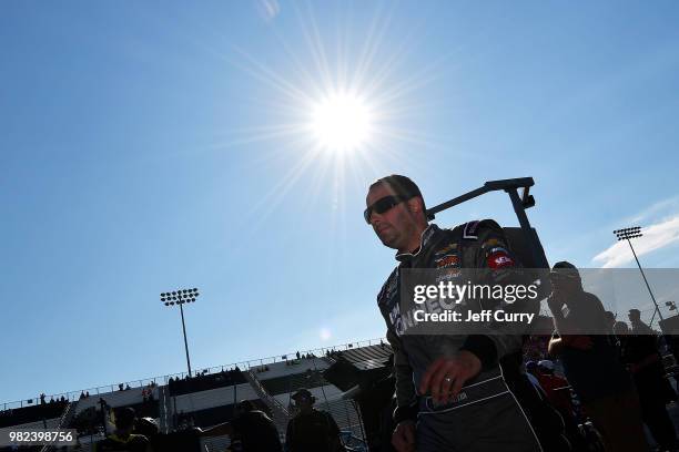 Johnny Sauter, driver of the ISM Connect Chevrolet, walks through the pits during qualifying for the NASCAR Camping World Truck Series Villa Lighting...