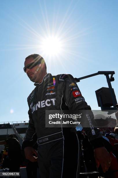 Johnny Sauter, driver of the ISM Connect Chevrolet, walks through the pits during qualifying for the NASCAR Camping World Truck Series Villa Lighting...