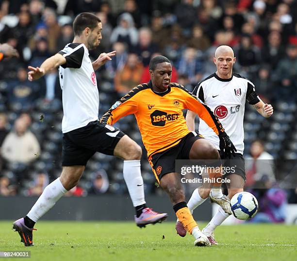 Charles N'Zogbia of Wigan Athletic is closed down by Paul Konchesky and Clint Dempsey of Fulham during the Barclays Premier League match between...