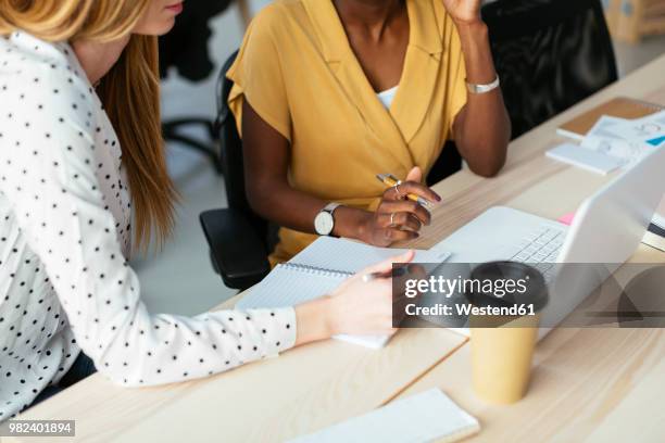 colleagues working together at desk in office - consultation at office desk imagens e fotografias de stock