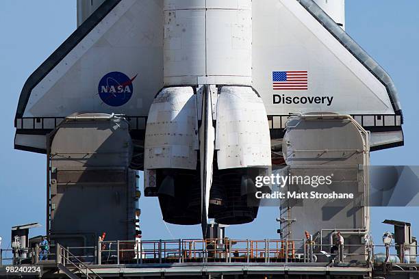 Space Shuttle Discovery sits on launch pad 39-A as the rotating service structure rolls back at Kennedy Space Center on April 4 in Cape Canaveral,...