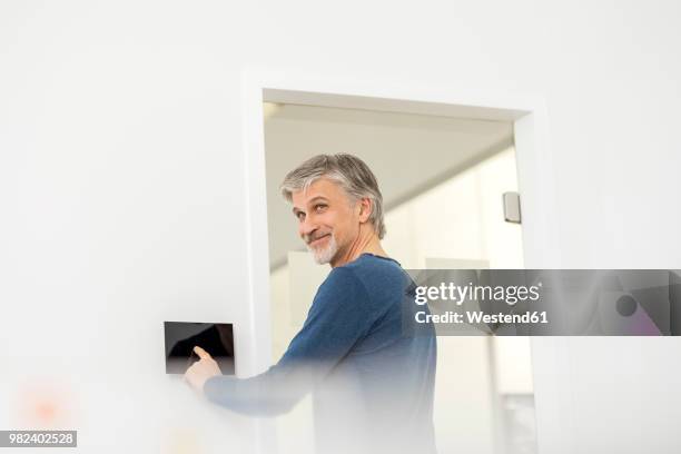 businessman in office with telecontrol - home technology stock-fotos und bilder