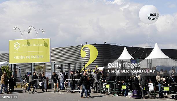 People queue to attend the annual meeting of French Muslims organized by the Union of Islamic Organisations of France in Le Bourget, outside Paris,...