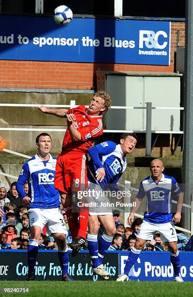 Dirk Kuyt of Liverpool goes up with Barry Ferguson of Birmingham during the Barclays Premier League match between Birmingham City and Liverpool at...