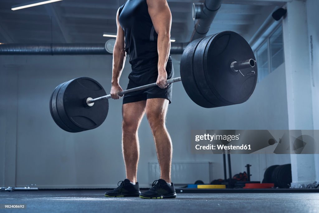 Athletic man doing deadlift exercise at gym