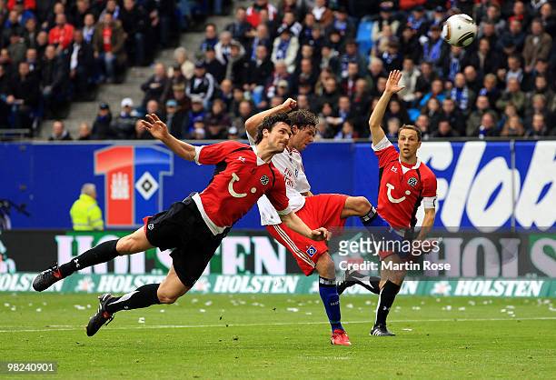 Marcus Berg of Hamburg and Karim Haggui of Hannover compete for the ball during the Bundesliga match between Hamburger SV and Hannover 96 at HSH...