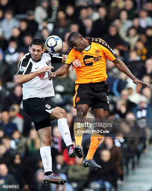 Clint Dempsey of Fulham jumps for a header with Maynor Figueroa of Wigan Athletic during the Barclays Premier League match between Fulham and Wigan...