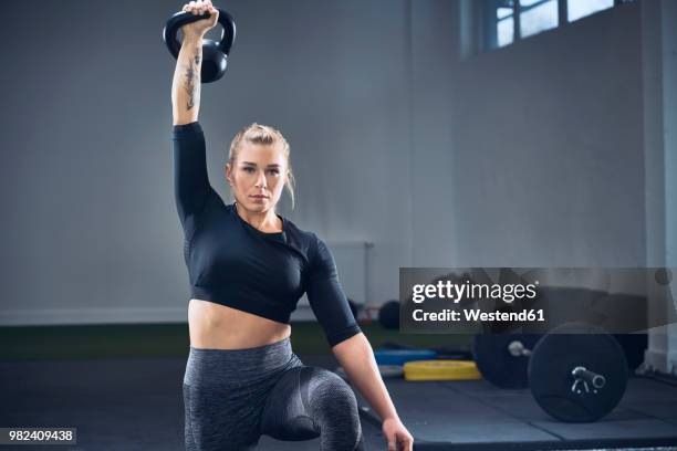 woman doing kettlebell exercise at gym - kettlebell imagens e fotografias de stock