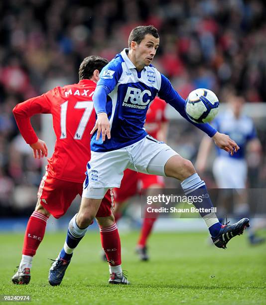 Keith Fahey of Birmingham City is challenged by Maxi Rodriguez of Liverpool during the Barclays Premier League match between Birmingham City and...