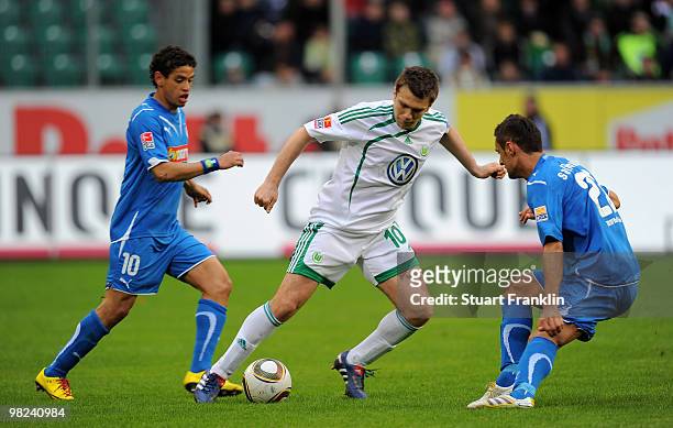 Zvjezdan Misimovic of Wolfsburg skips past a challenge by Carlos Eduardo and Sejad Salihovic of Hoffenheim during the Bundesliga match between VfL...