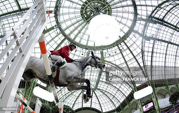 Belgian Jos Lansink riding King Kolibri competes in the International Jumping Competition on April 04 at The Grand Palais in Paris. AFP PHOTO /...