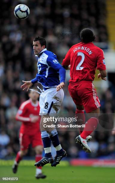 Keith Fahey of Birmingham City is challenged by Glen Johnson of Liverpool during the Barclays Premier League match between Birmingham City and...