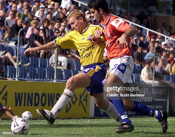 Peter Bennett of Parramatta is tackled by Ante Deur of Sydney United during the round 23 NSL match between Sydney United and Parramatta Power played...