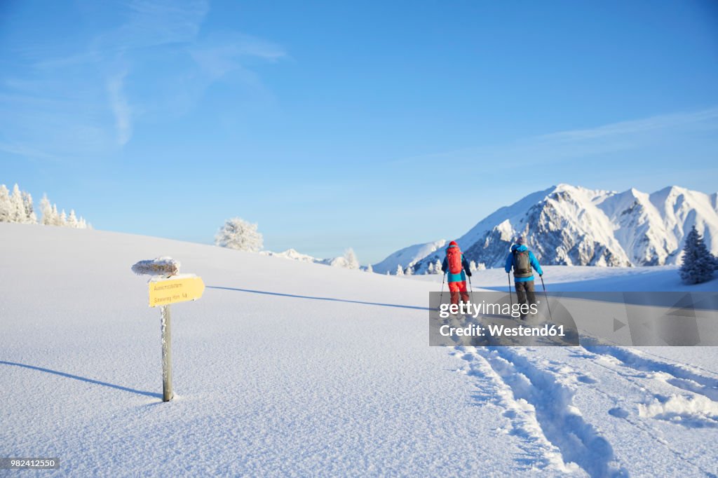 Austria, Tyrol, couple snowshoeing
