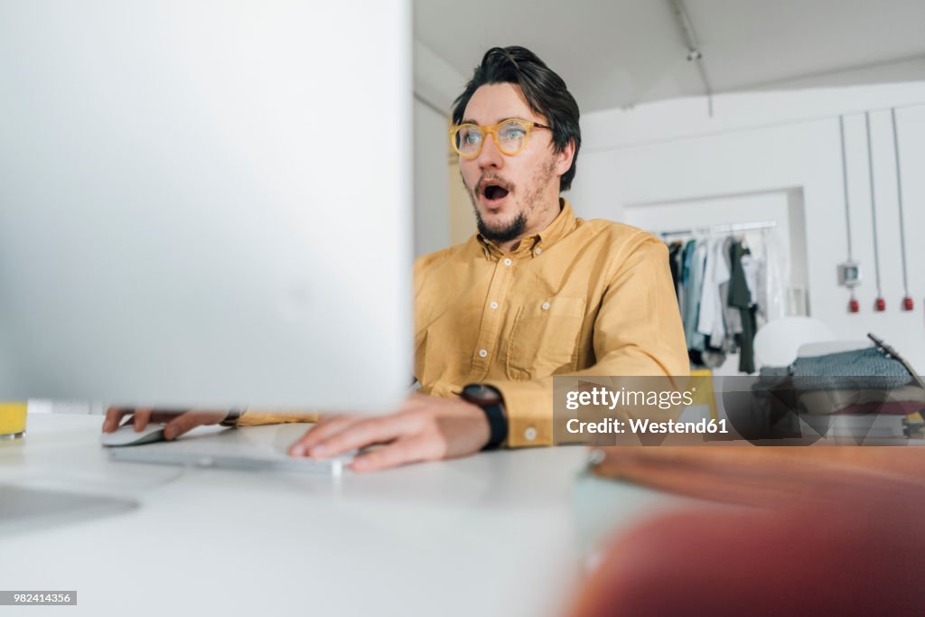 Portrait of scared freelancer working on computer
