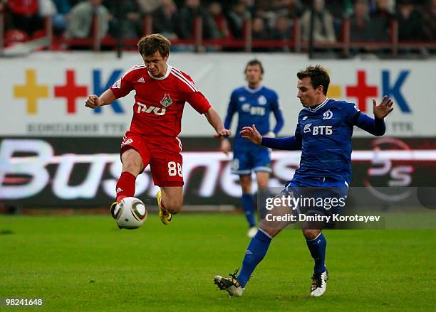 Oleksandr Aliyev of FC Lokomotiv Moscow battles for the ball with Luke Wilkshire of FC Dynamo Moscow during the Russian Football League Championship...