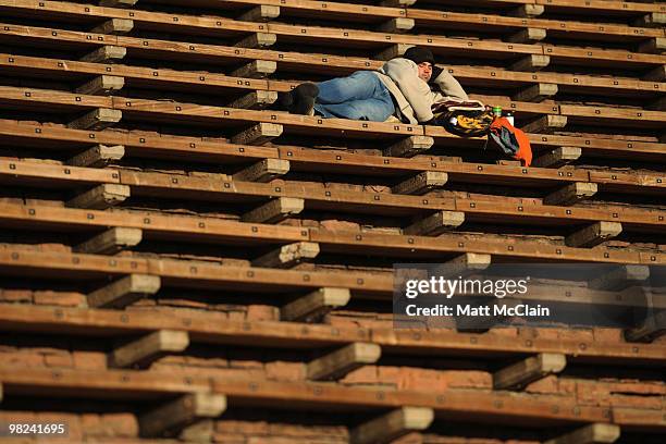Dave Hageman of Denver, Colorado takes a nap while waiting for traffic to leave following the sixty-third annual Easter Sunrise Service at Red Rocks...