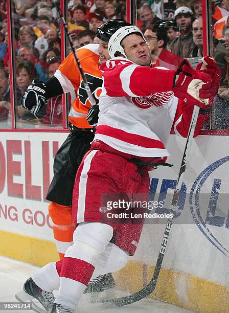 Ian Laperriere of the Philadelphia Flyers collides with Brett Lebda of the Detroit Red Wings along the boards on April 4, 2010 at the Wachovia Center...