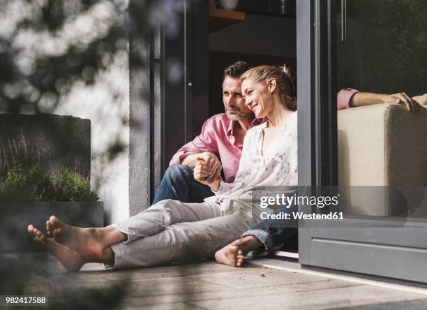 content mature couple relaxing together at open terrace door - 40 49 år bildbanksfoton och bilder