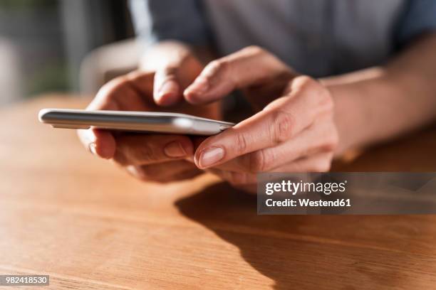 woman's hands text messaging, close-up - phone on table stock pictures, royalty-free photos & images