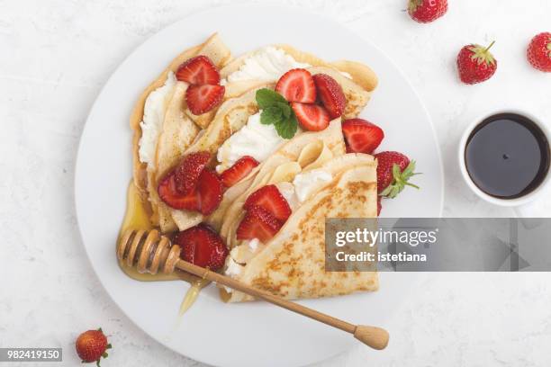 summer treat, healthy breakfast with crepes, fresh strawberry, cheese and coffee - crepe pancake stock pictures, royalty-free photos & images