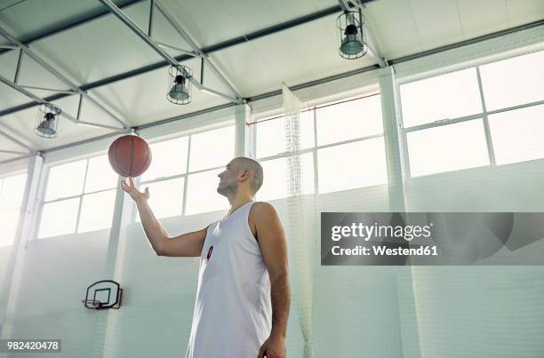 man playing with basketball, indoor - sports balls foto e immagini stock