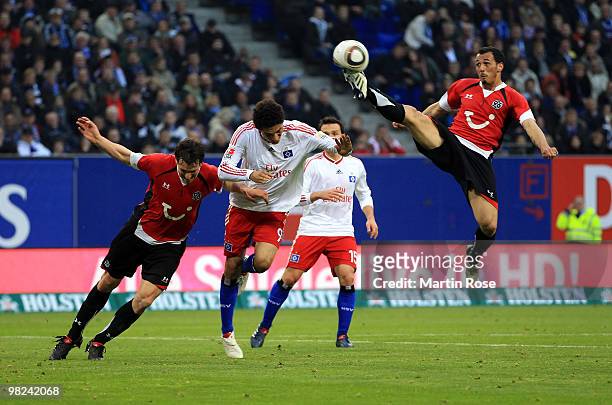 Paolo Guerrero of Hamburg, Steven Cherundolo and Mario Eggimann of Hannover compete for the ball during the Bundesliga match between Hamburger SV and...