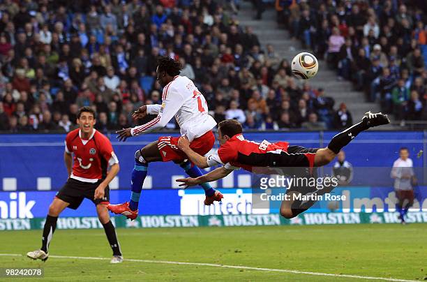 Jonathan Pitroipa of Hamburg and Steven Cherundolo of Hannover compete for the ball during the Bundesliga match between Hamburger SV and Hannover 96...