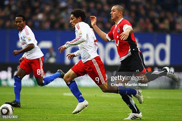Paolo Guerrero of Hamburg and Leon Andreasen of Hannover compete for the ball during the Bundesliga match between Hamburger SV and Hannover 96 at HSH...