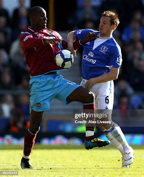 Carlton Cole of West Ham United tussles for posession with Phil Jagielka of Everton during the Barclays Premier League match between Everton and West...