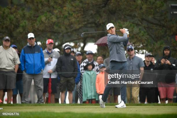 Brooks Koepka watches his tee shot on the 5th hole during the third round of the Travelers Championship at TPC River Highlands in Cromwell, Conn., on...