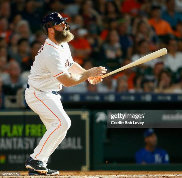 Evan Gattis of the Houston Astros flies out to center field in the second inning against the Kansas City Royals at Minute Maid Park on June 23, 2018...