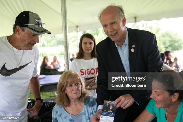 Representative Dan Donovan, a Republican from New York, second right, speaks with attendees during a campaign stop at the Mount Loretto Food Truck...