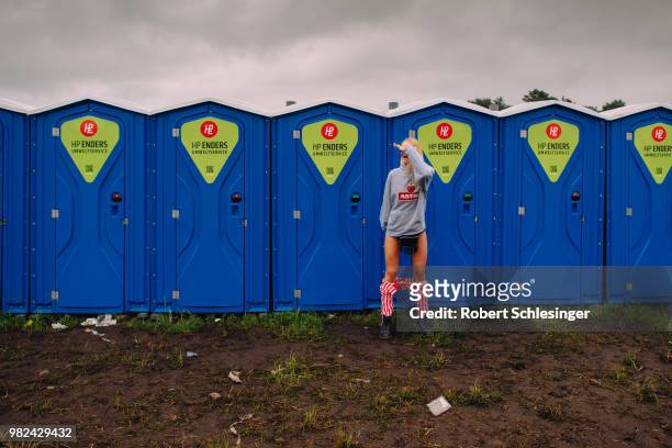 Festival goer in front of toilets during the second day of the Hurricane festival on June 23, 2018 in Scheessel, Germany.