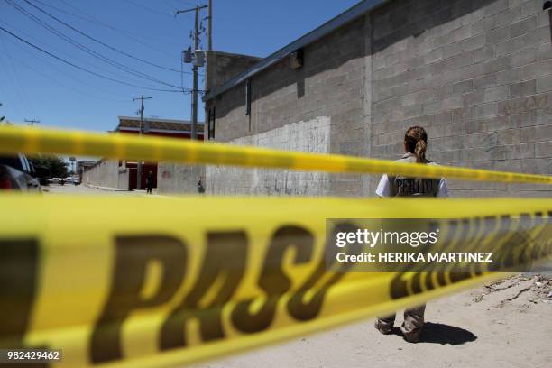 Experts and police officers work at the scene, where five men and a woman were murdered in Ciudad Juarez, Chihuahua state, Mexico on June 23, 2018. -...