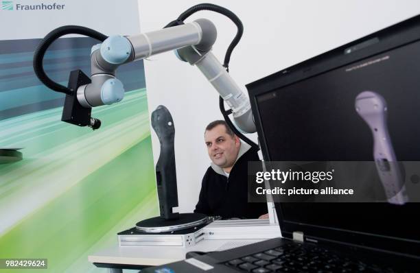 Pedro Santos of the Fraunhofer Institute for Computer Graphics Research presents an autonomously working 3D laser scanner during a press conference...