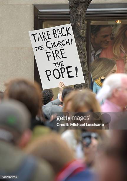 An activist holds up a sign in protest out front St. Patrick's Cathedral during the annual Easter Parade on April 4, 2010 in New York City. The...