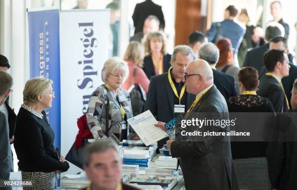 Congress participants informs himself at the stand of the Behoerden Spiegel' newspaper during the European Police Congress in Berlin, Germany, 06...