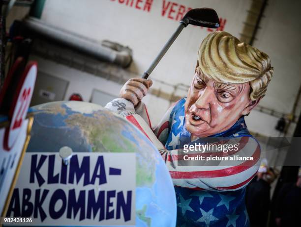 Dpatop - A theme wagon with a caricature depicting US President Donald Trump smashing the Climate Agreement with a golf club, on display as part of...