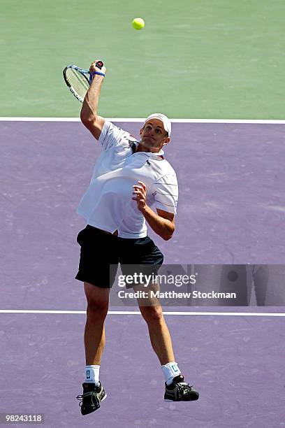 Andy Roddick of the United States jumps up to smash a return against Tomas Berdych of the Czech Republic during the men's final of the 2010 Sony...