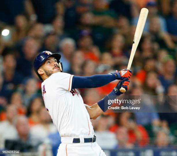 Carlos Correa of the Houston Astros hits a sacrifice fly in the fourth inning against the Kansas City Royals at Minute Maid Park on June 23, 2018 in...