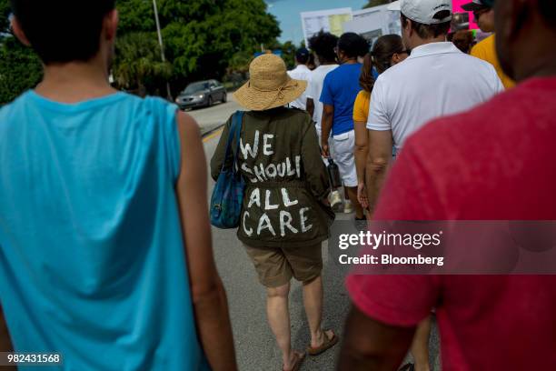 Demonstrators walk during the "Keep Families Together" rally outside of the Homestead temporary shelter for unaccompanied migrant children in...