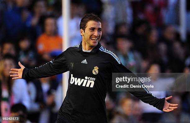 Gonzalo Higuain of Real Madrid celebrates after scoring Real's second goal during the La Liga match between Racing Santander and Real Madrid at El...