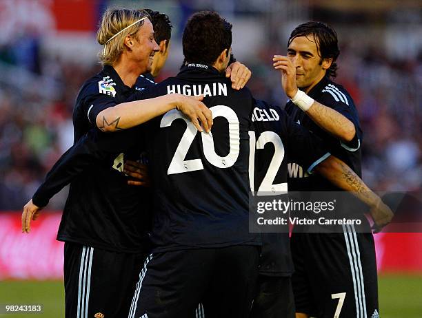 Gonzalo Higuain of Real Madrid celebrates with Guti and Raul Gonzalez during the La Liga match between Racing Santander and Real Madrid at El...