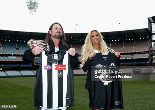 World champion AJ Styles and Smackdown women's champion Carmella pose for photos as they are presented with football jumpers at the Melbourne Cricket...