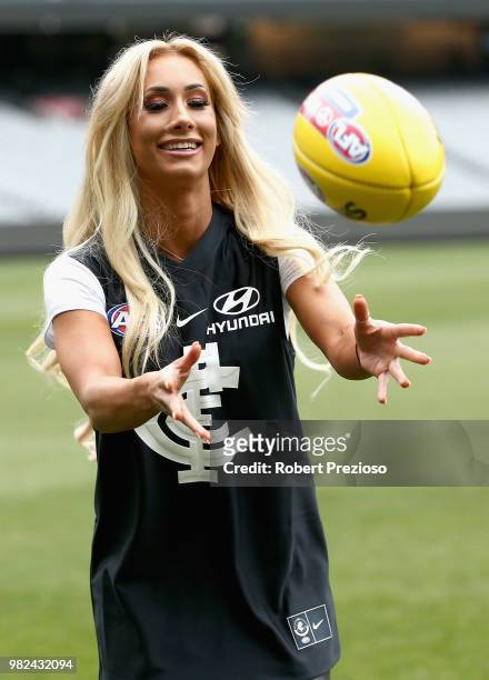 Smackdown women's champion Carmella and WWE'S world champion AJ Styles show their football skills at the Melbourne Cricket Ground on June 24, 2018 in...