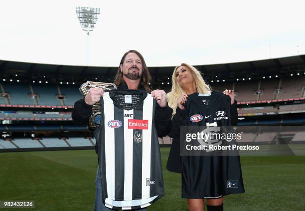 World champion AJ Styles and Smackdown women's champion Carmella pose for photos as they are presented with football jumpers at the Melbourne Cricket...