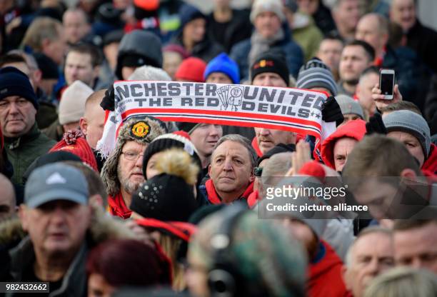 Soccer fan holding up a Manchester United scarf during a memorial service for the victims of the Manchester United air crash at the Manchester Square...