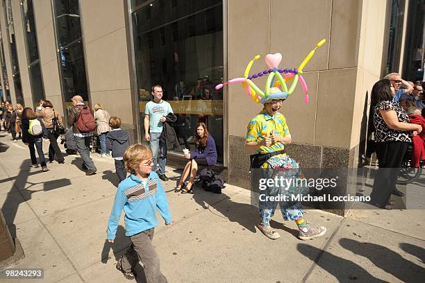 Clown that makes balloon-animal hats takes part in the annual Easter Parade bonnet and costume-wearing festivities on April 4, 2010 in New York City....